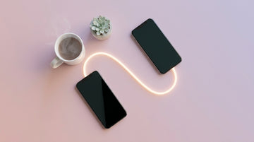 Two smartphones linked by a glowing light line on a pastel surface — app-controlled and long-distance toys