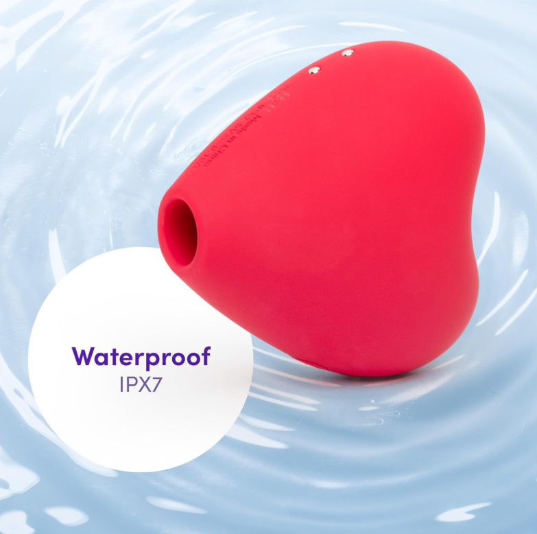 Heart-shaped sucking jumping egg — red heart clitoral suction vibrator with USB charging cable (product set image)