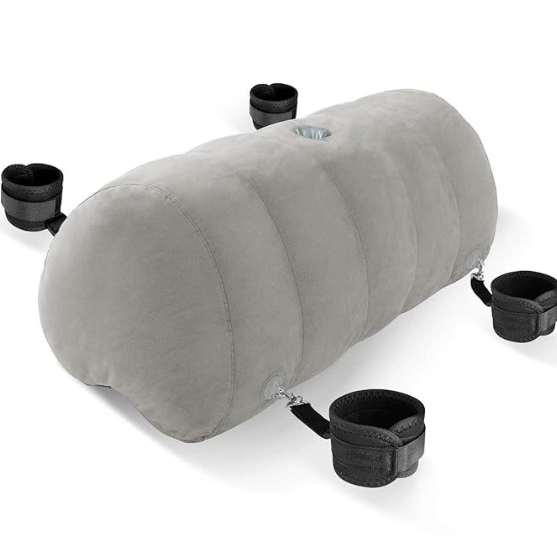 Heart-shaped inflatable pillow with attached bondage cuffs, cross strap and nipple clamps